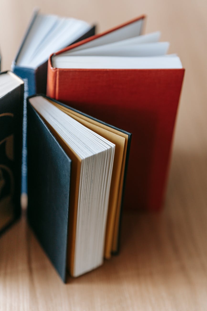set of interesting books placed on wooden table in library